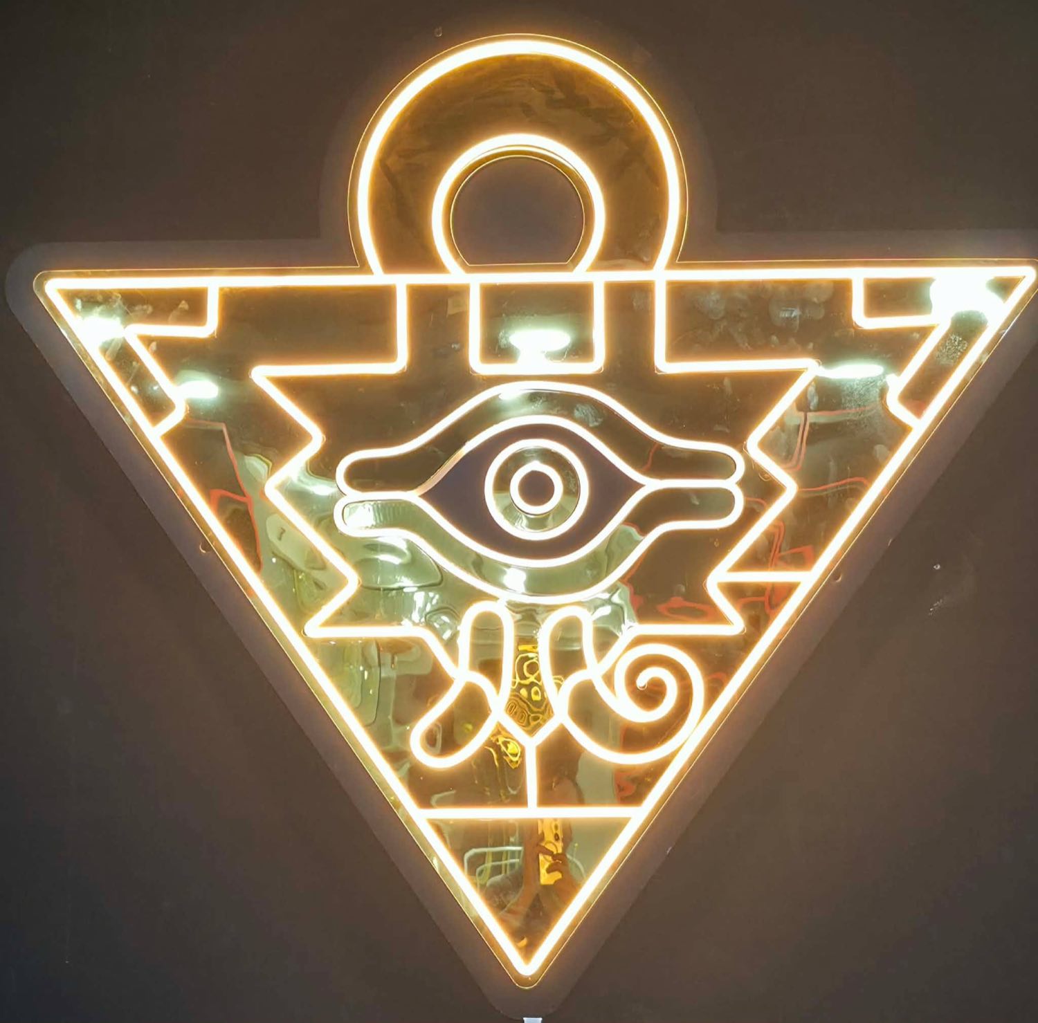 The Millennium Puzzle neon sign on the wall inside Dark Side